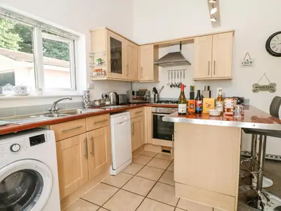 a kitchen with a washer and a dishwasher at Little Westwards in Penzance