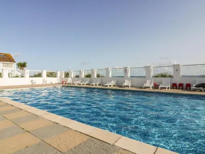 a large swimming pool with chairs on a building at Fistral Surf in Newquay