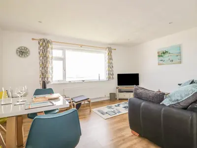 a living room with a couch and a table at Fistral Surf in Newquay