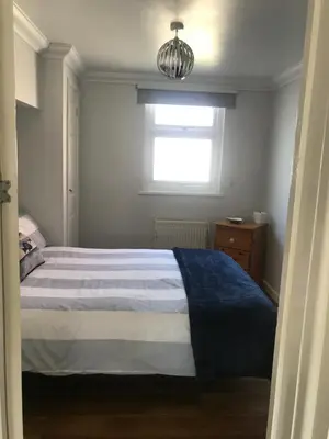 a small bedroom with a bed and a window at Kiki’s Corner in Newquay