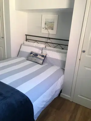a bedroom with a bed with a lamp on it at Kiki’s Corner in Newquay