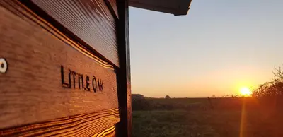 a view of the sunset from the side of a building at Little Oaks Chalet - St. Merryn, Padstow in Padstow