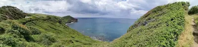 a view of a body of water between two mountains at THE OLD RECTORY ROSE COTTAGE in Jacobstow 10 mins to Widemouth bay and Crackington Haven,Nearby Bude,Tintagel,Port Issac,Clovelly,PARKING FOR LARGE AND MULTIPLE VEHICLES in Jacobstow