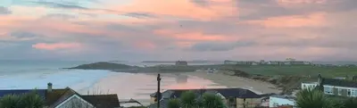 a view of a beach at sunset with a cloudy sky at Fistral Hideaway in Newquay