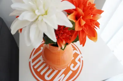 a vase filled with flowers sitting on a table at Stones Throw in Newquay