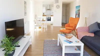a living room with a couch and a table at Stones Throw in Newquay