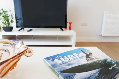 a book sitting on a coffee table in a living room at Stones Throw in Newquay