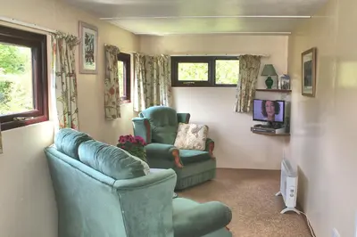 a living room with two chairs and a couch at The Chalet at Mellowvean in St. Agnes