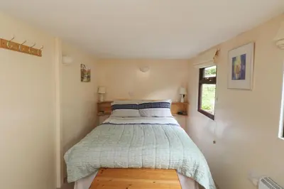 a bedroom with a bed in a small room at The Chalet at Mellowvean in St. Agnes