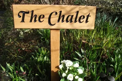 a sign that reads the chalker in front of flowers at The Chalet at Mellowvean in St. Agnes