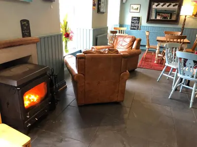 a living room with a couch and a fireplace at The Cornubia Inn in Hayle