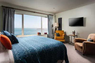 a hotel room with a bed and a large window at The Lewinnick Lodge in Newquay