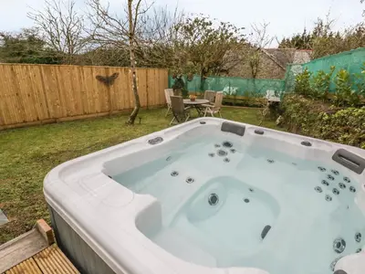 a jacuzzi tub in a backyard at Crift Farm Cottage in Bodmin