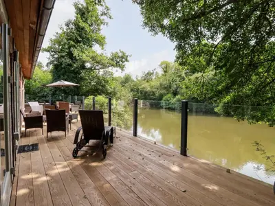 a deck with a view of a river at 6 Water's Edge in Looe