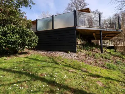 a house on top of a grassy hill at 4 Water's Edge in Looe