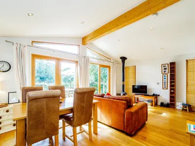 a living room with a table and a couch at 2 Water's Edge in Looe
