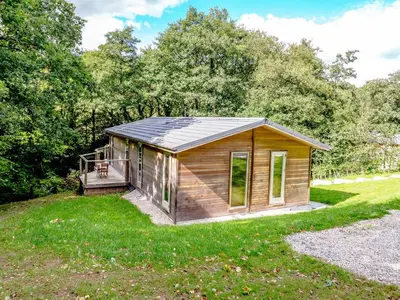 a tiny house with a porch in a yard at 8 Streamside in Looe