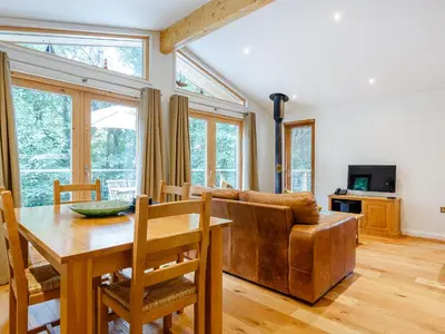 a living room with a table and a couch at 8 Streamside in Looe