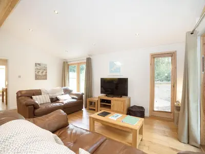 a living room with a couch and a tv at 7 Streamside in Looe