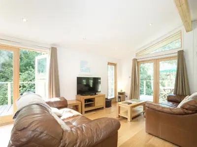 a living room with a couch and a television at 7 Streamside in Looe