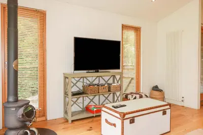 a living room with a flat screen tv and a fireplace at 4 Stonerush Valley in Looe
