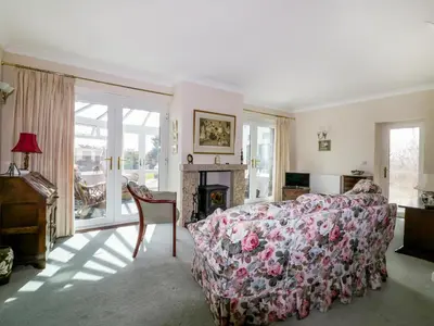 a living room with a couch and a fireplace at Sheila's Cottage in Penryn