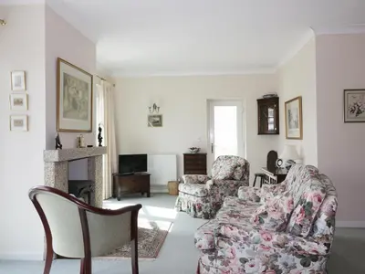 a living room with a couch and a chair at Sheila's Cottage in Penryn