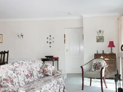 a living room with a couch and a chair at Sheila's Cottage in Penryn