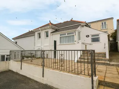 a white house with a fence in front of it at Treleigh in Hayle