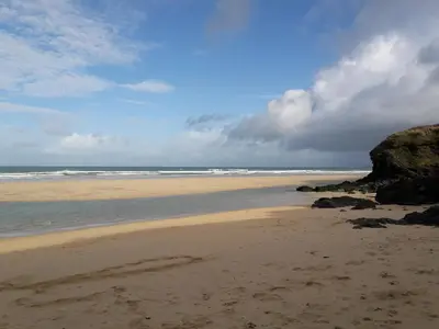 a sandy beach with rocks and the ocean at Treleigh in Hayle