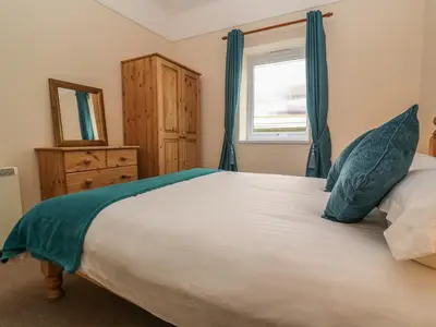 a bedroom with a large bed and a window at Treleigh in Hayle