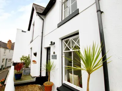 a white house with plants in front of it at The Shell Seekers in Fowey
