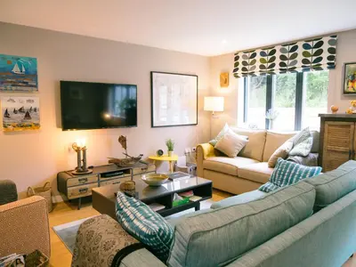a living room with two couches and a tv at Sidings at Brunel Two in Lostwithiel