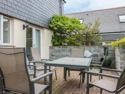a table and chairs on a brick patio at Sorrel Cottage in Padstow