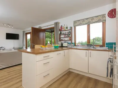 a kitchen with white cabinets and a sink at Tressa, Tor Down Quarry in Bodmin