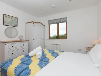a bedroom with a bed with towels on it at Tressa, Tor Down Quarry in Bodmin
