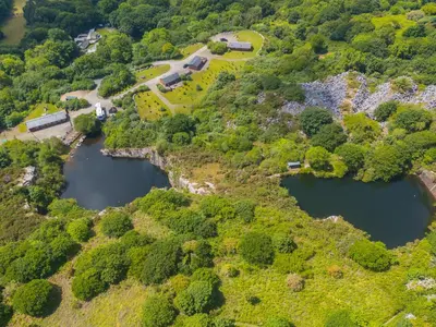 an aerial view of two reservoirs on a hill at Tressa, Tor Down Quarry in Bodmin