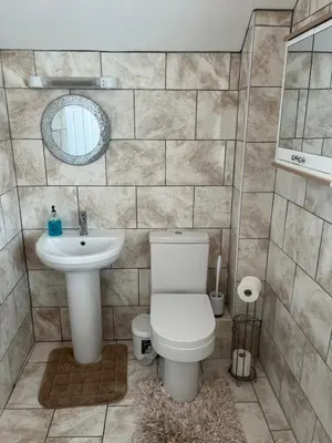 a bathroom with a toilet and a sink at Jasmine House in Newquay