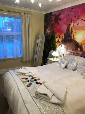 a bedroom with a bed with towels on it at Jasmine House in Newquay