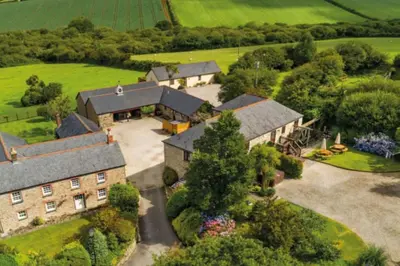 an aerial view of a large house with a yard at Wheel House @ Goonwinnow Farm in Newquay