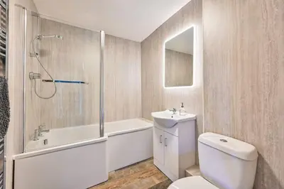 a bathroom with a toilet and a sink and a shower at Mill House @ Goonwinnow Farm in Newquay