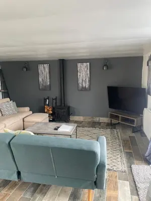 a living room with a couch and a tv at The Piggery @ Goonwinnow Farm in Newquay
