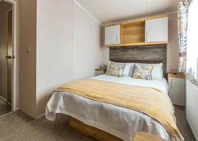 a bedroom with a large bed in a room at Trevornick Holiday Park in Holywell Bay