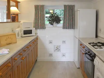 a kitchen with a white refrigerator and a microwave at Granny's Cottage in Lostwithiel
