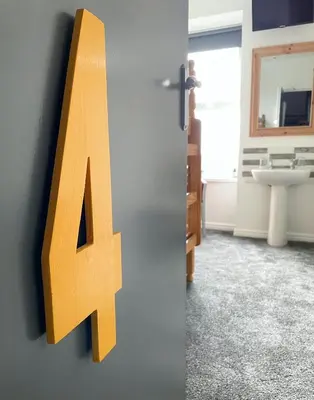 a letter alphabet on the wall of a bathroom at Breakers Guest House in Newquay