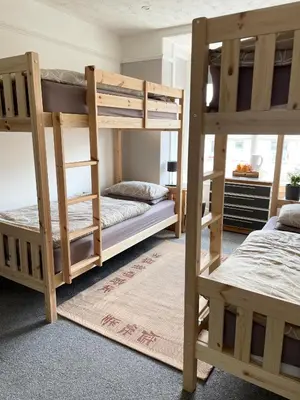 a bedroom with two bunk beds in a room at Breakers Guest House in Newquay