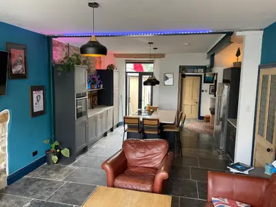 a kitchen and dining room with a table and chairs at Fistral Court in Newquay