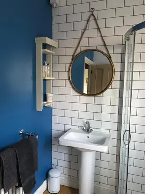 a bathroom with a sink and a mirror at Fistral Court in Newquay