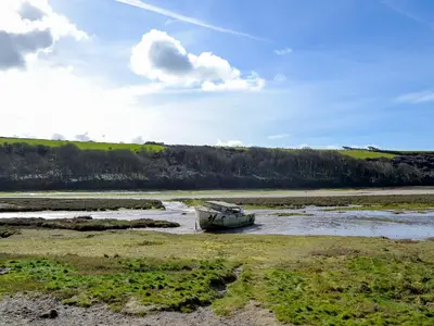 a boat sitting in the middle of a river at Towan View in Newquay