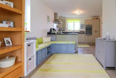 a kitchen with blue and white cabinets and a counter at MODERN HOLIDAY HOME central St Merryn in St Merryn